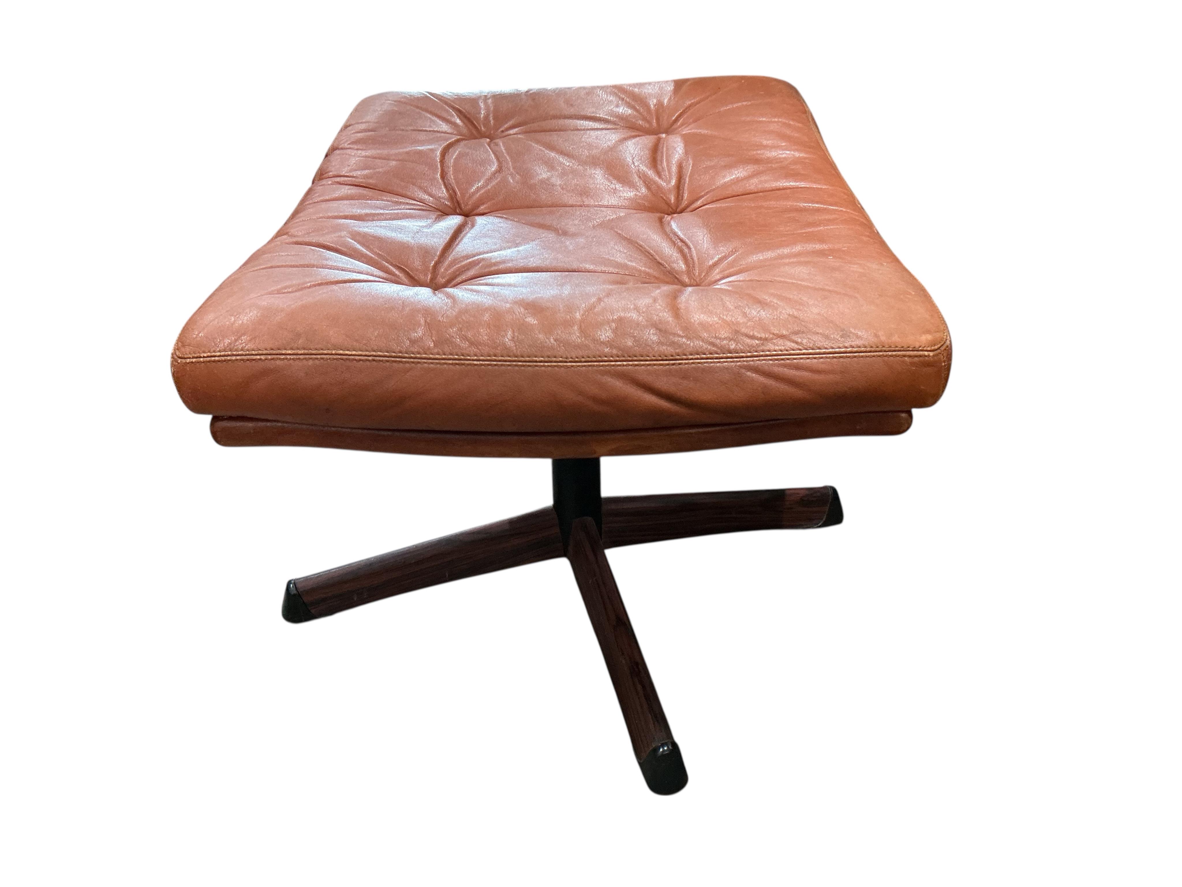 A mid century Swedish Gote Mobler leather swivel chair, width 74cm, depth 80cm, height 86cm and footstool